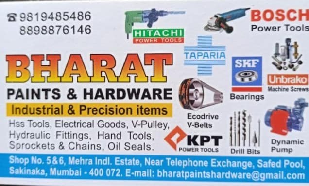 A collection of various hardware and measuring tools laid out on a wooden surface